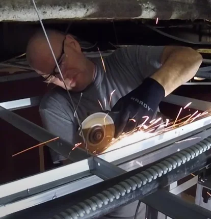 commercial-plumbing-apprentice-cutting-steel-studs-for-drain